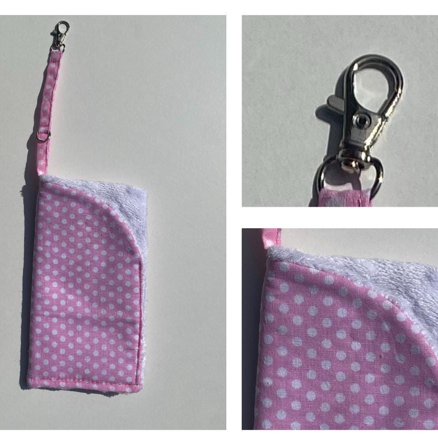 A soft padded glasses case in polka dot cotton and soft white velour lining. The glasses case also benefits from a lobster clip and key ring to fix to a bag strap, belt loop or just to hook.