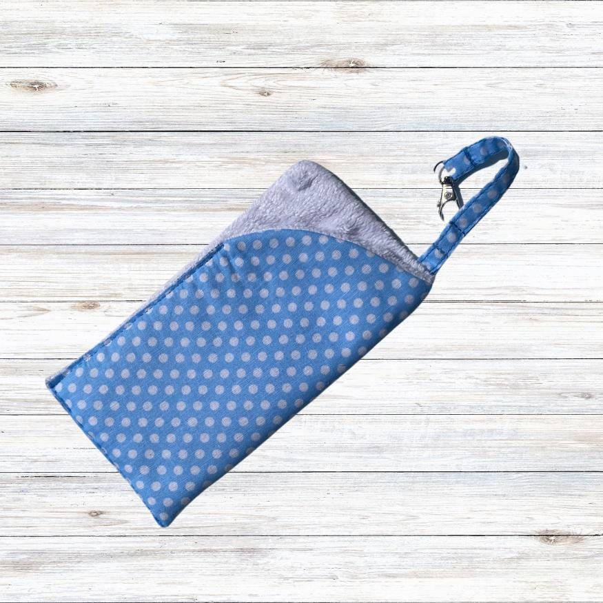 A soft padded glasses case in polka dot cotton and soft white velour lining. The glasses case also benefits from a lobster clip and key ring to fix to a bag strap, belt loop or just to hook.